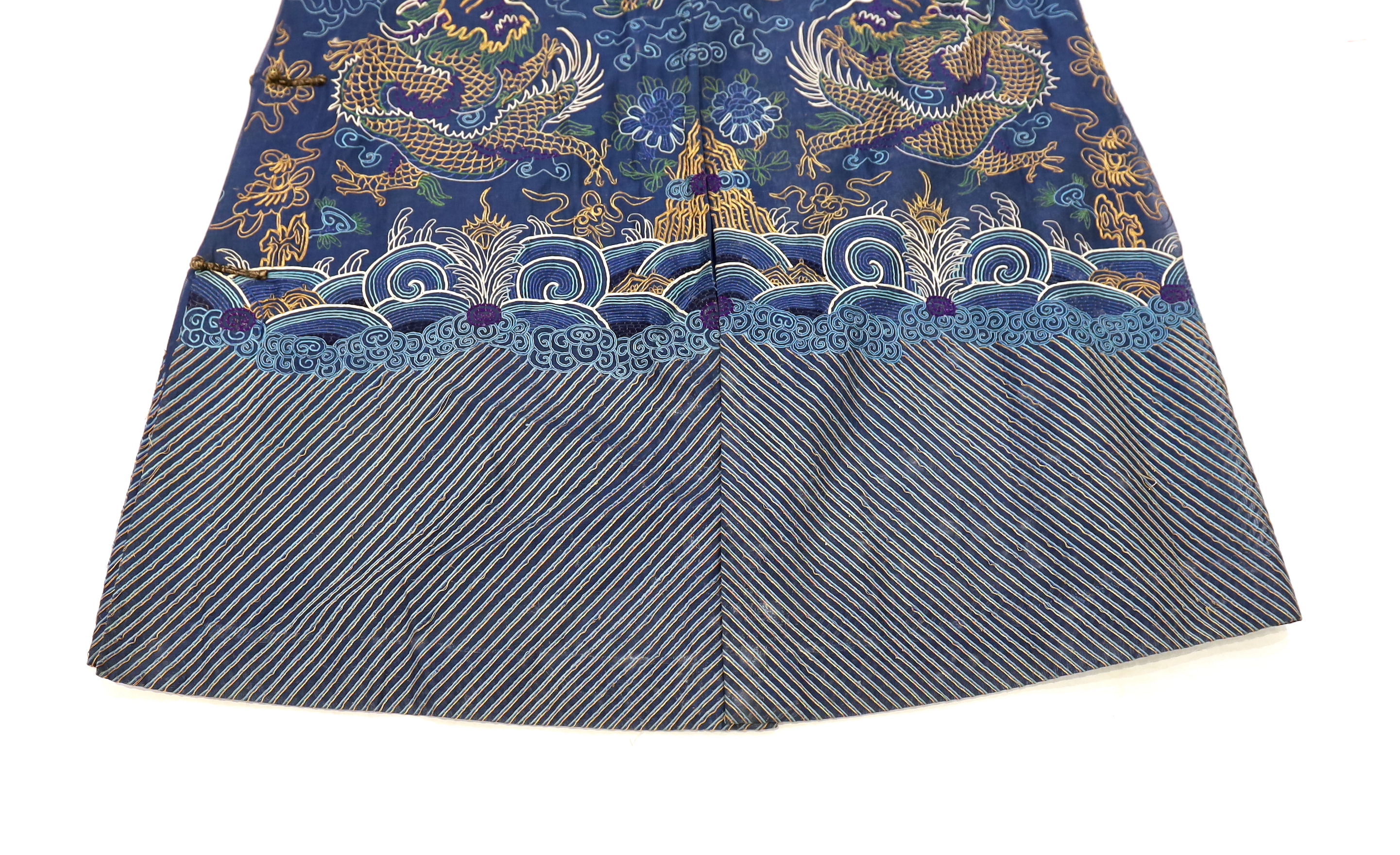 A Chinese fine blue gauze summer robe embroidered with a gold thread dragon highlighted by coloured silk embroidery together with a similar gauze panel embroidered with dragons, 163cm x 75cm